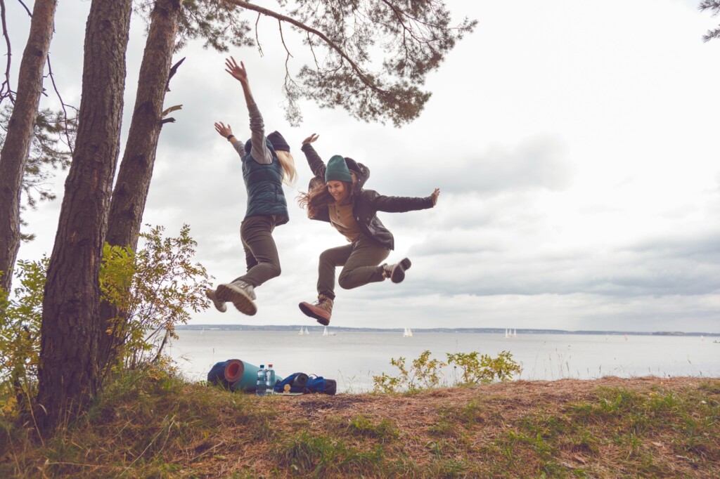 Happy travelers women jumping. Team success concept