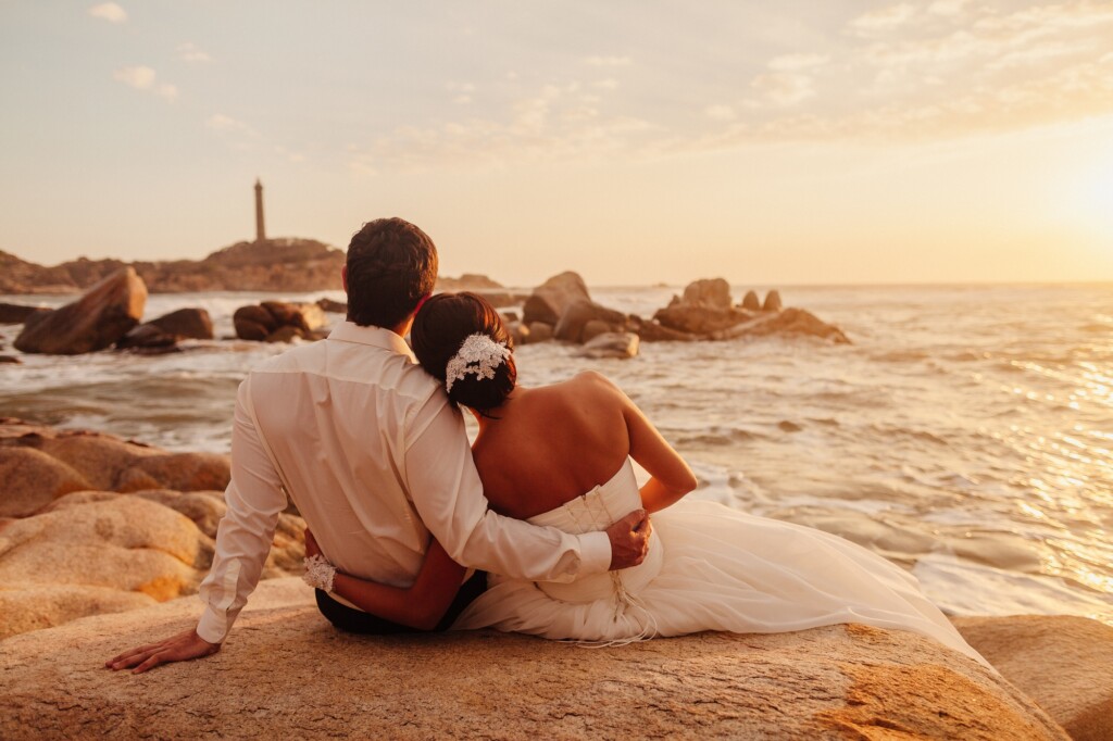 honeymoon couple relax on sunset beach